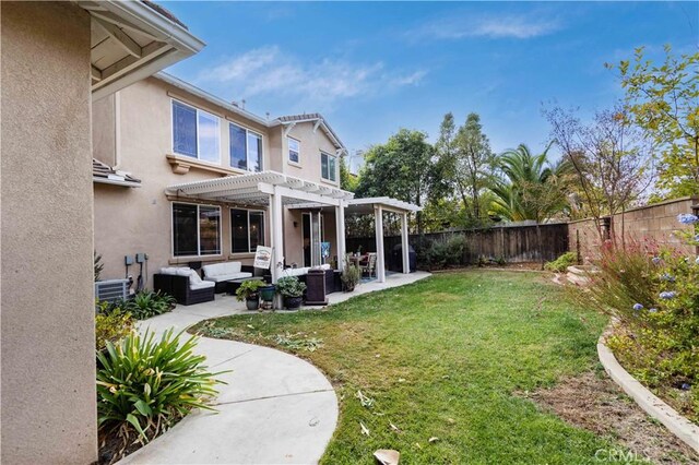 view of yard featuring a pergola, outdoor lounge area, a patio, and central air condition unit