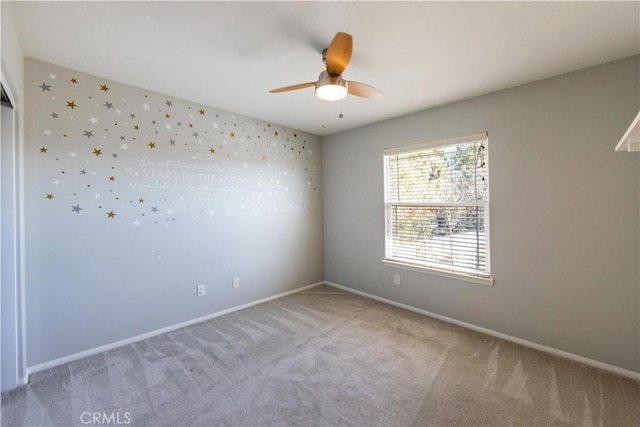 empty room with ceiling fan and carpet floors