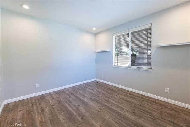 spare room with dark wood-type flooring