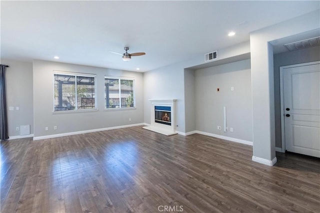 unfurnished living room with ceiling fan and dark hardwood / wood-style flooring