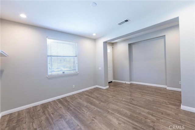 unfurnished room with hardwood / wood-style flooring