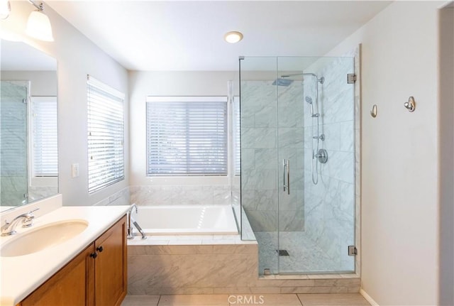 bathroom with vanity, tile patterned floors, and plus walk in shower