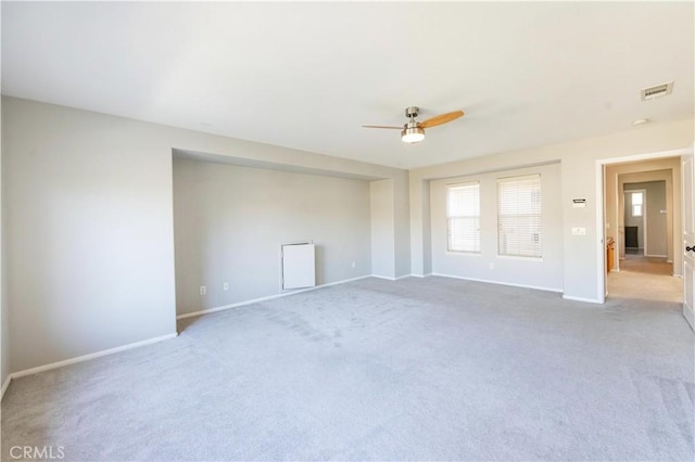 carpeted spare room featuring ceiling fan