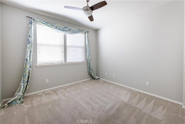 carpeted spare room featuring ceiling fan