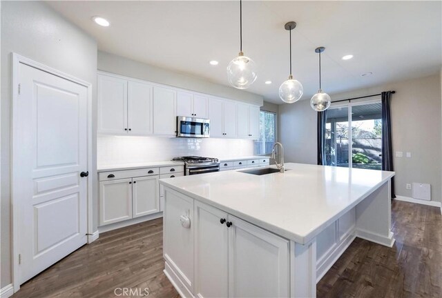 kitchen with white cabinetry, sink, an island with sink, and appliances with stainless steel finishes