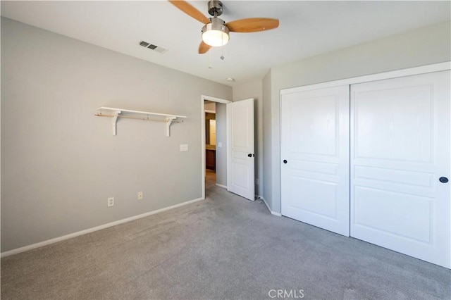 unfurnished bedroom with light colored carpet, a closet, and ceiling fan