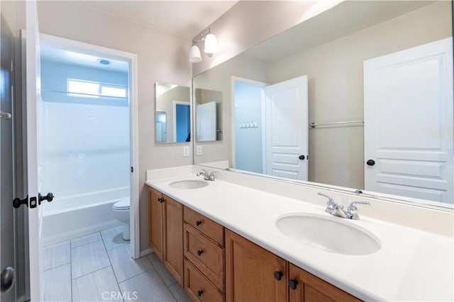 full bathroom featuring vanity, tile patterned floors, toilet, and bathtub / shower combination