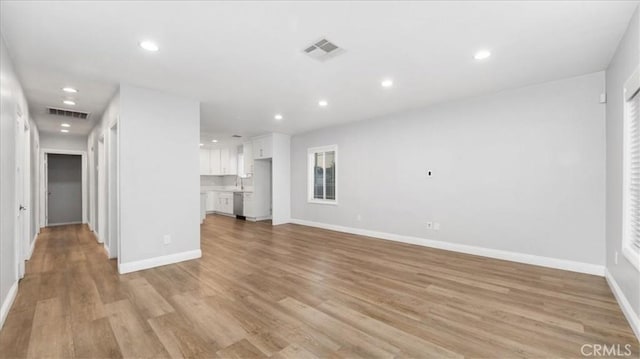 unfurnished living room with recessed lighting, visible vents, and light wood finished floors