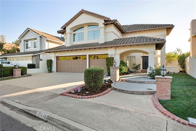 mediterranean / spanish house featuring a garage