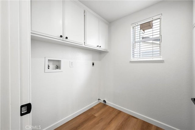 laundry area featuring hardwood / wood-style floors, electric dryer hookup, cabinets, and washer hookup