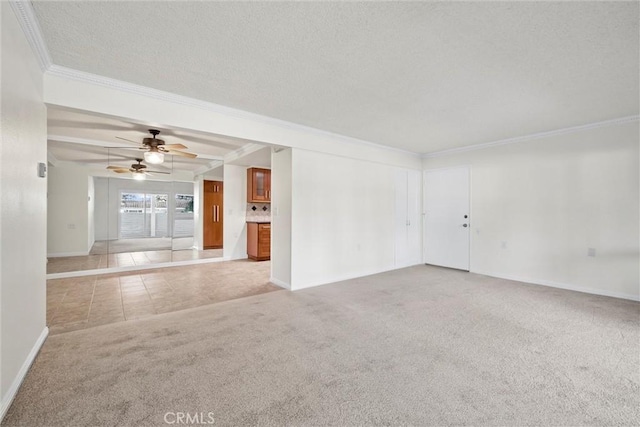 unfurnished room with light carpet, ceiling fan, a textured ceiling, and ornamental molding