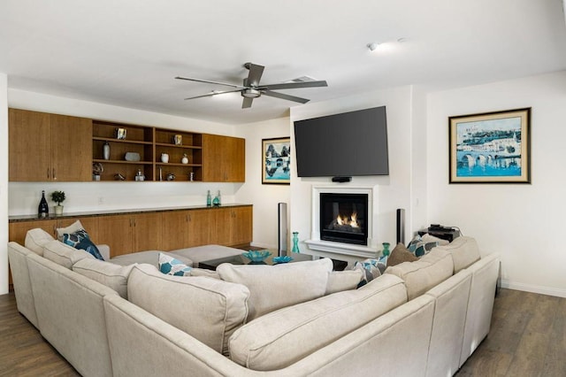 living room with dark hardwood / wood-style floors and ceiling fan