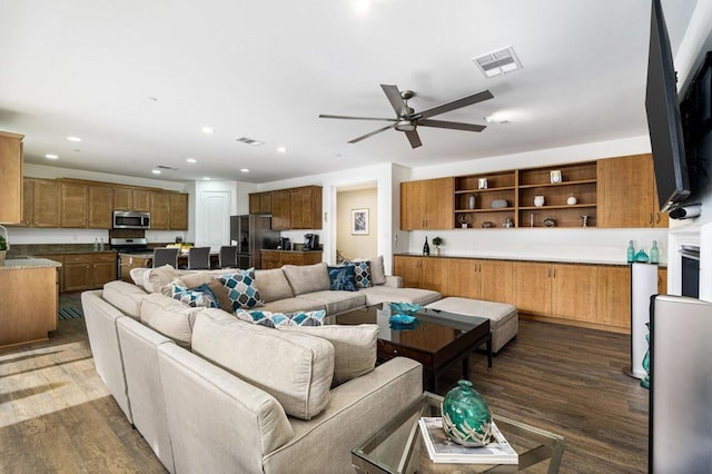 living room with dark hardwood / wood-style floors and ceiling fan