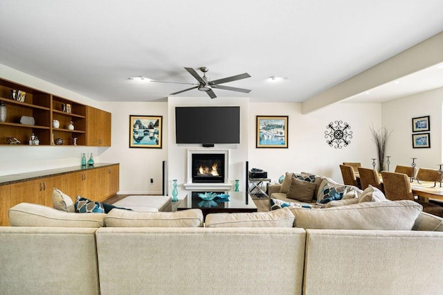 living room with beamed ceiling and ceiling fan