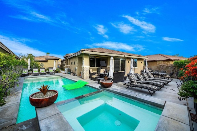 view of pool featuring an in ground hot tub and a patio