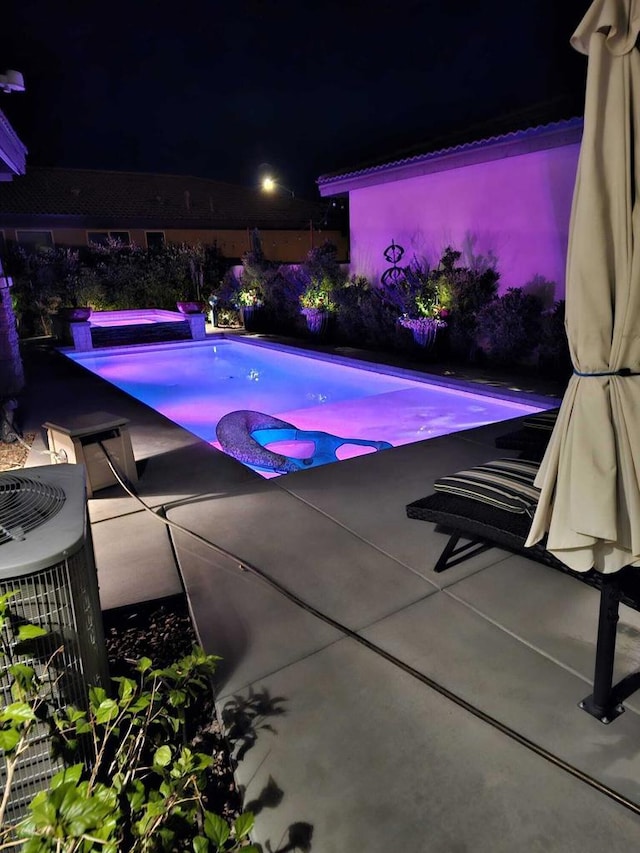 pool at night with central air condition unit