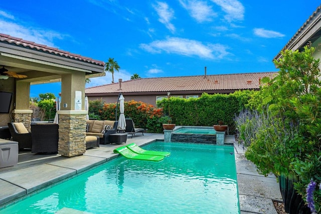 view of pool with an in ground hot tub, an outdoor living space, and a patio area