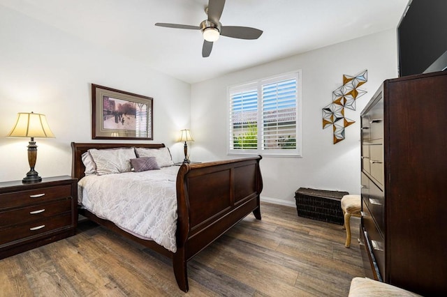 bedroom with ceiling fan and dark wood-type flooring