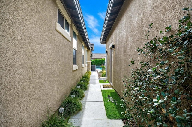 view of side of property with central air condition unit