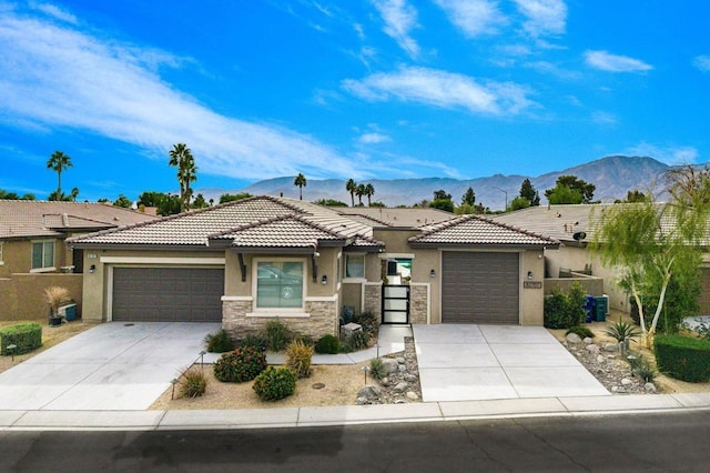 view of front of house featuring a mountain view and a garage