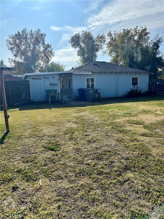 back of house with a lawn