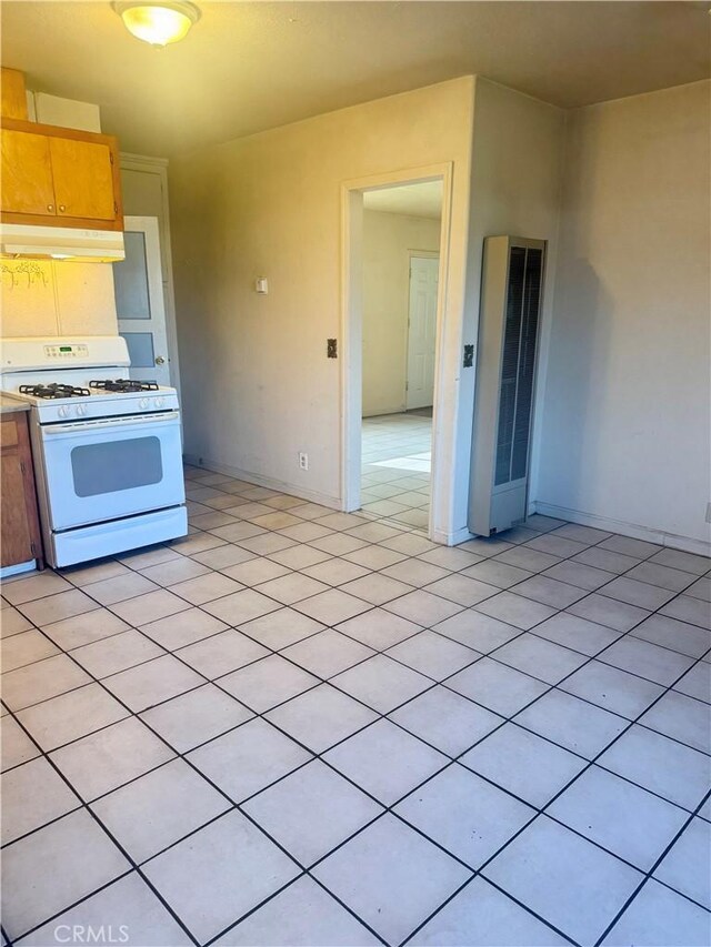 kitchen with light tile patterned floors and white range with gas stovetop