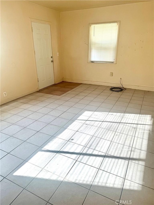 spare room with light tile patterned flooring