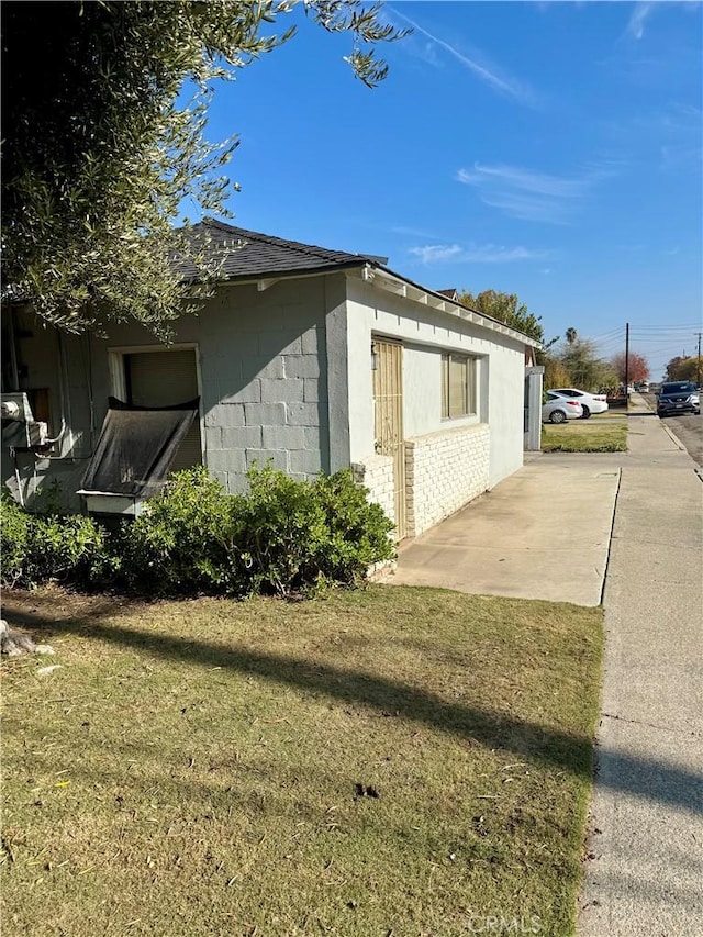 view of property exterior featuring a lawn