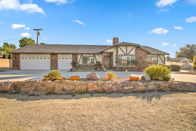 19985 Red Feather Rd, Apple Valley, CA 92307 - view of front of property with a chimney, concrete driveway, an attached garage, stucco siding, and brick siding