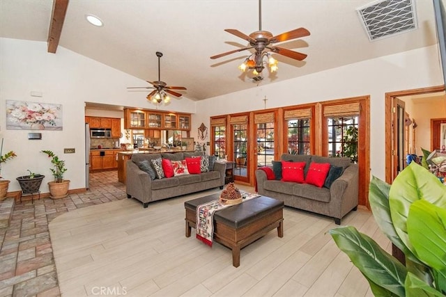 living room with vaulted ceiling with beams, ceiling fan, and light hardwood / wood-style flooring