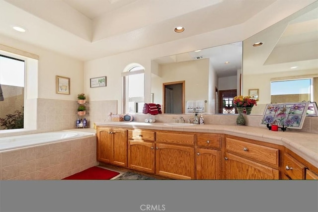 19985 Red Feather Rd, Apple Valley, CA 92307 - bathroom with healthy amount of natural light, vanity, a bath, and recessed lighting