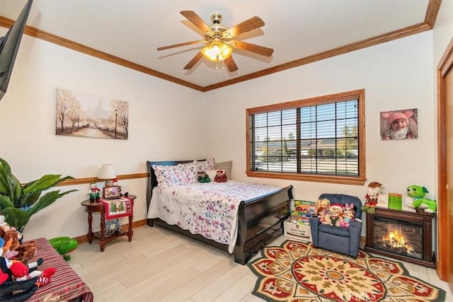 19985 Red Feather Rd, Apple Valley, CA 92307 - bedroom featuring light wood-style flooring, ornamental molding, a ceiling fan, and a glass covered fireplace