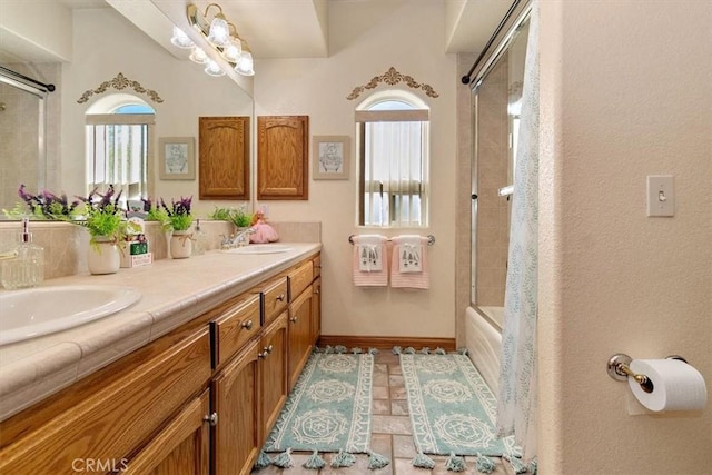 bathroom featuring vanity and bath / shower combo with glass door