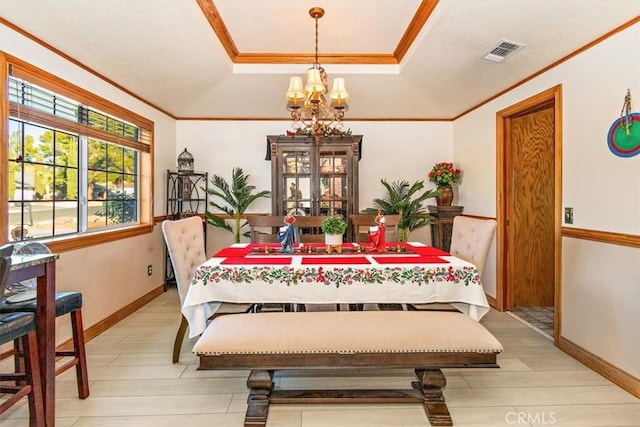 19985 Red Feather Rd, Apple Valley, CA 92307 - dining room featuring ornamental molding, a chandelier, light wood-type flooring, and a tray ceiling