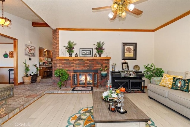 living room featuring hardwood / wood-style floors, ornamental molding, and a fireplace