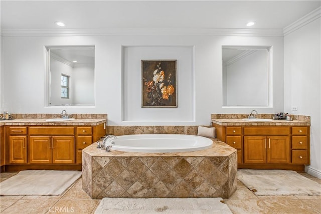 bathroom featuring tile patterned flooring, vanity, crown molding, and tiled tub