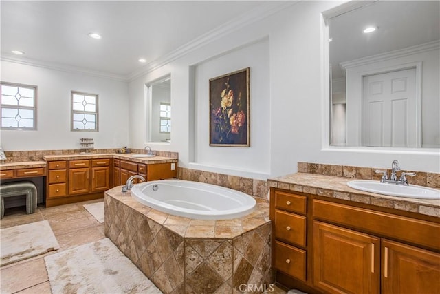 bathroom with vanity, a relaxing tiled tub, and crown molding