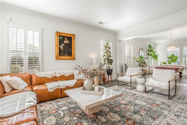 living room with wood-type flooring and crown molding