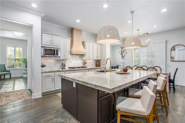 kitchen featuring white cabinets, sink, dark wood-type flooring, and custom exhaust hood