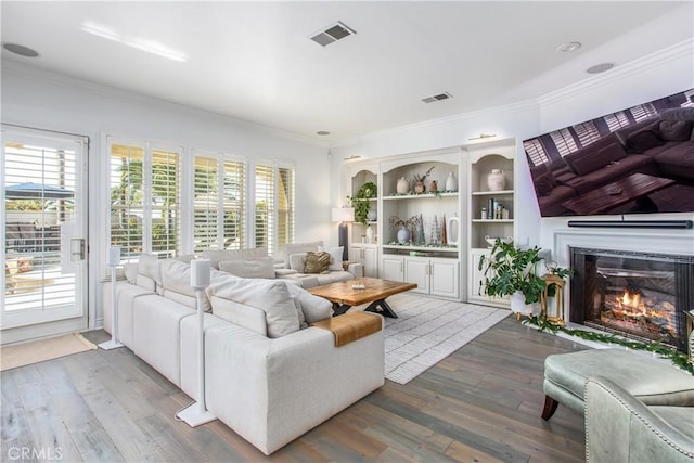 living room with crown molding and hardwood / wood-style floors