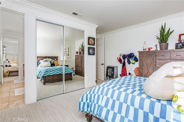 bedroom featuring light carpet, a closet, and ornamental molding