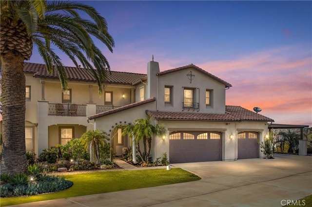 mediterranean / spanish-style house featuring a yard, a balcony, and a garage