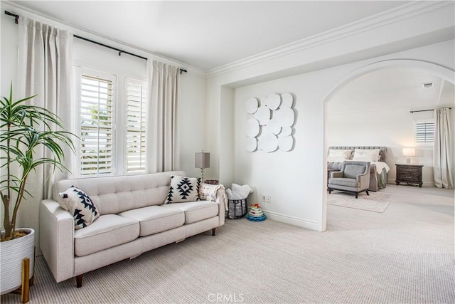 carpeted living room featuring ornamental molding