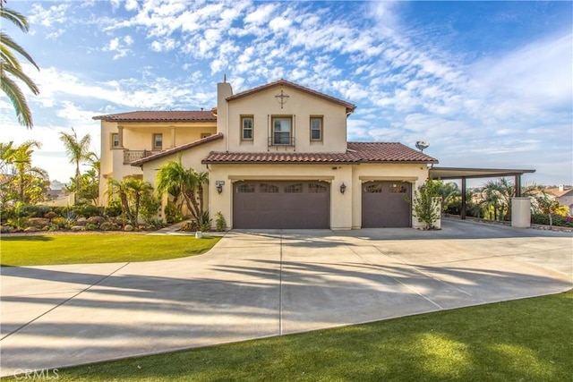 mediterranean / spanish house with a garage and a front yard