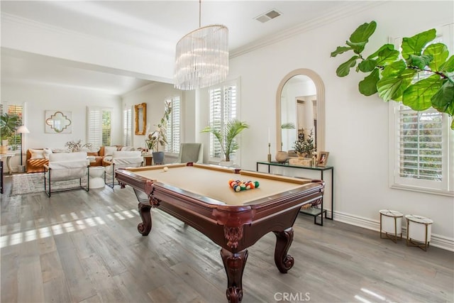 rec room with pool table, wood-type flooring, ornamental molding, and a wealth of natural light