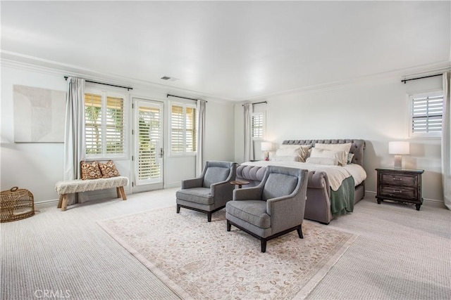 bedroom featuring light colored carpet, crown molding, and access to outside