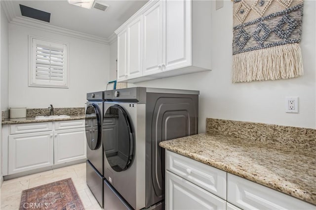 washroom with sink, cabinets, light tile patterned floors, washer and dryer, and ornamental molding