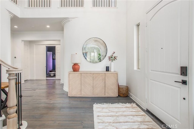 entryway with dark hardwood / wood-style floors and ornamental molding