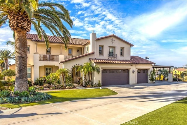 mediterranean / spanish house with a garage and a balcony