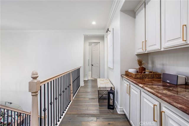 corridor with dark hardwood / wood-style flooring and crown molding